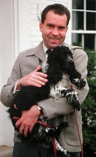 Richard Nixon and Checkers, shown in 1959. / AP